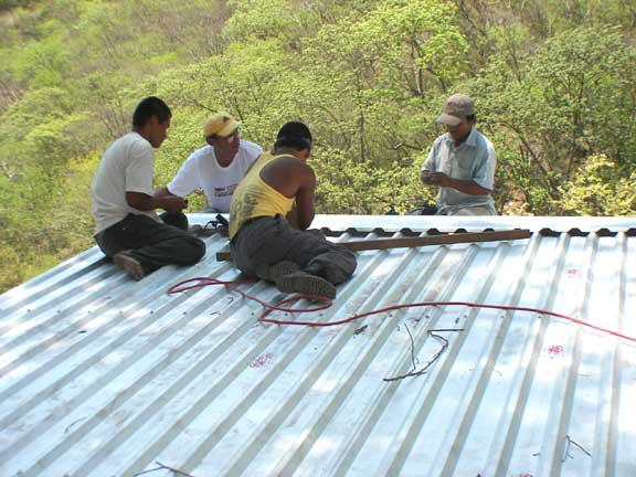 Installing the ridgecap on the top of the roof