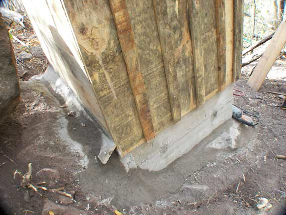 Latrine backside showing mortar work for rainwater protection