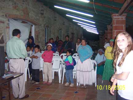 Pastor Dagoberto leading Huichols in prayer