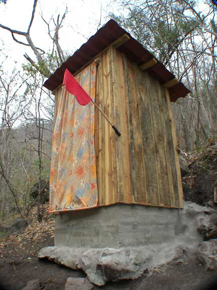 The curtain door and "ocupado" flag added to outhouse